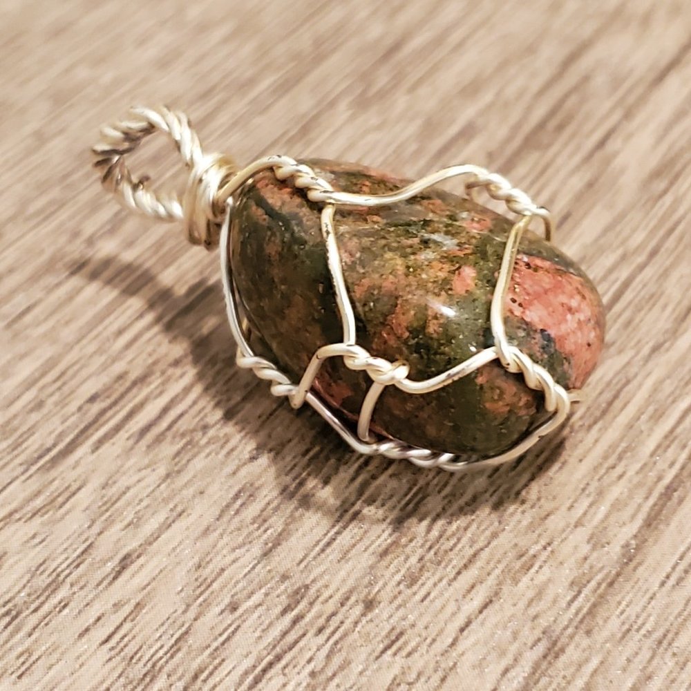 Smooth marble granite wrapped in silver wire